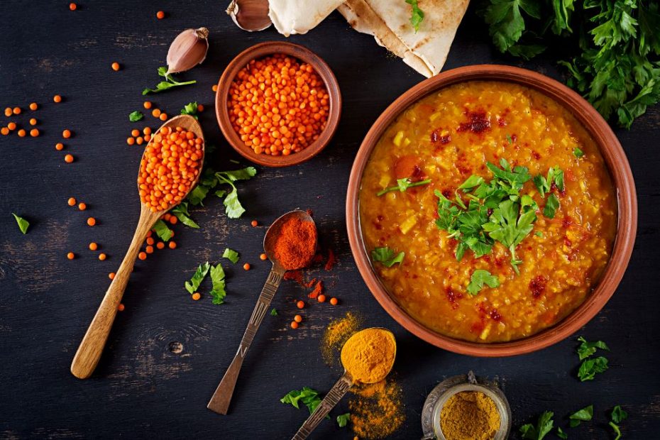 traditional indian soup lentils indian dhal spicy curry bowl spices herbs rustic black wooden table